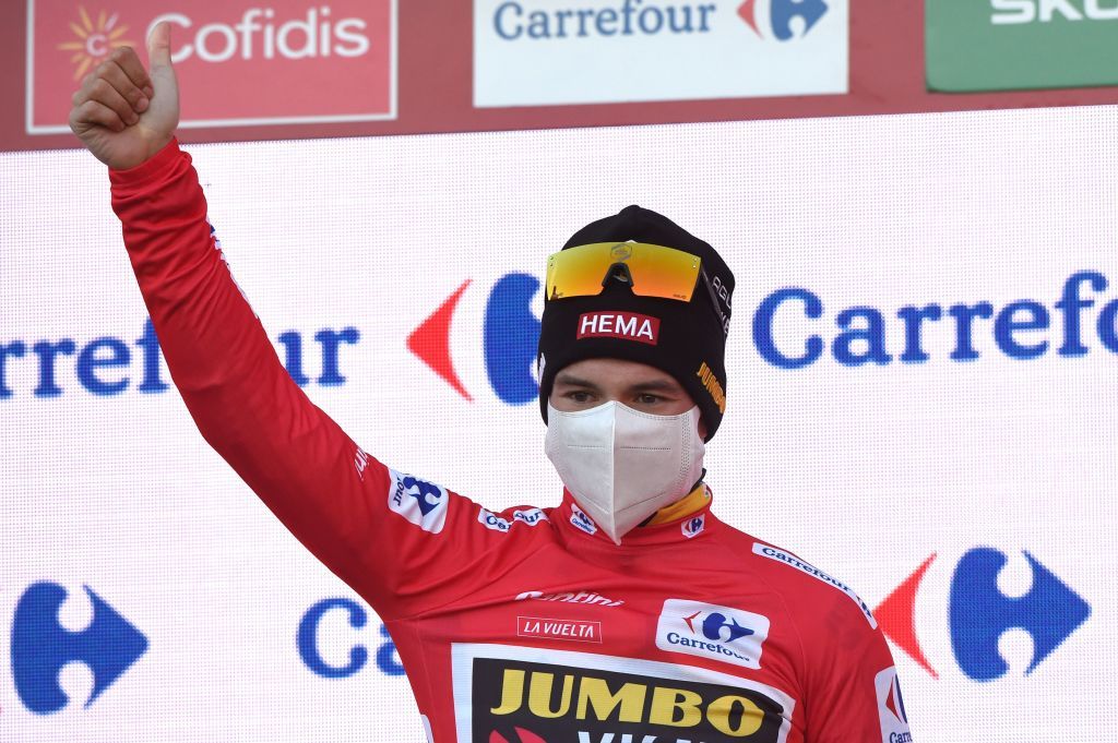 Team Jumbo rider Slovenias Primoz Roglic celebrates on the podium regaining the red jersey of the overall leader after winning the 13th stage of the 2020 La Vuelta cycling tour of Spain a 337km individual timetrial from Muros to Mirador de Ezaro Dumbria on November 3 2020 Slovenian Primoz Roglic claimed victory in the Vuelta a Espana time trial on today to regain the lead in the overall classification Roglic took back the red jersey from Ecuadors Richard Carapaz while Britains Hugh Carthy sits third ahead of the races climax on November 1 2020 Photo by MIGUEL RIOPA AFP Photo by MIGUEL RIOPAAFP via Getty Images