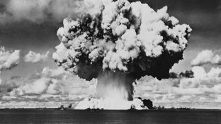 A black and white photo of a large mushroom cloud from a nuclear blast