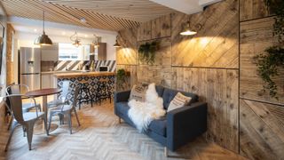 rustic kitchen living room with herringbone floor and layered lighting scheme