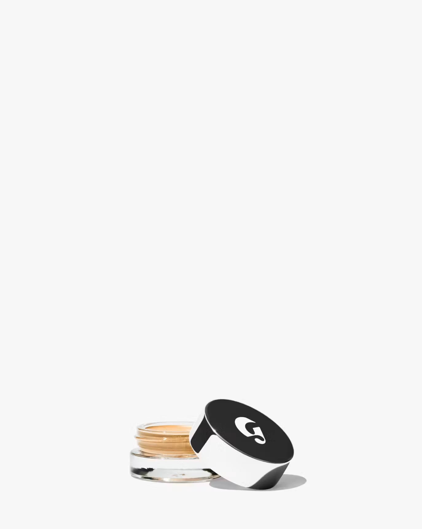 a shot of glossier's stretch concealer in light 2 with the top off the cannister