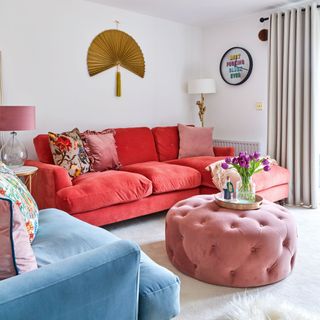 Living room with pink chaise sofa and round pink footstool