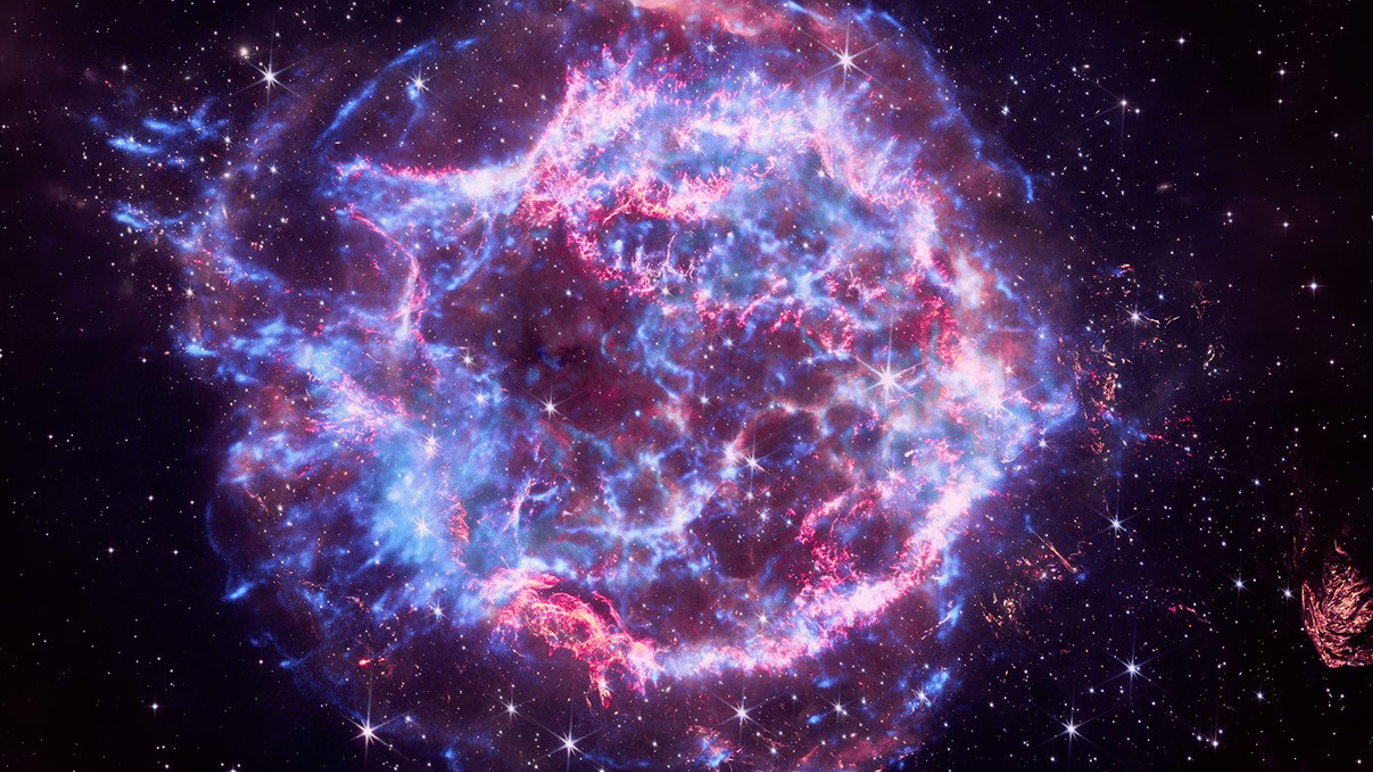 A cosmic image rendered in red, white, and blue that represent the wonders of the universe that NASA explores