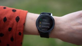 OnePlus Watch runt en handled med träningsappen igång.