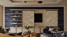 living room with tv hidden behind screen panels fronted by art