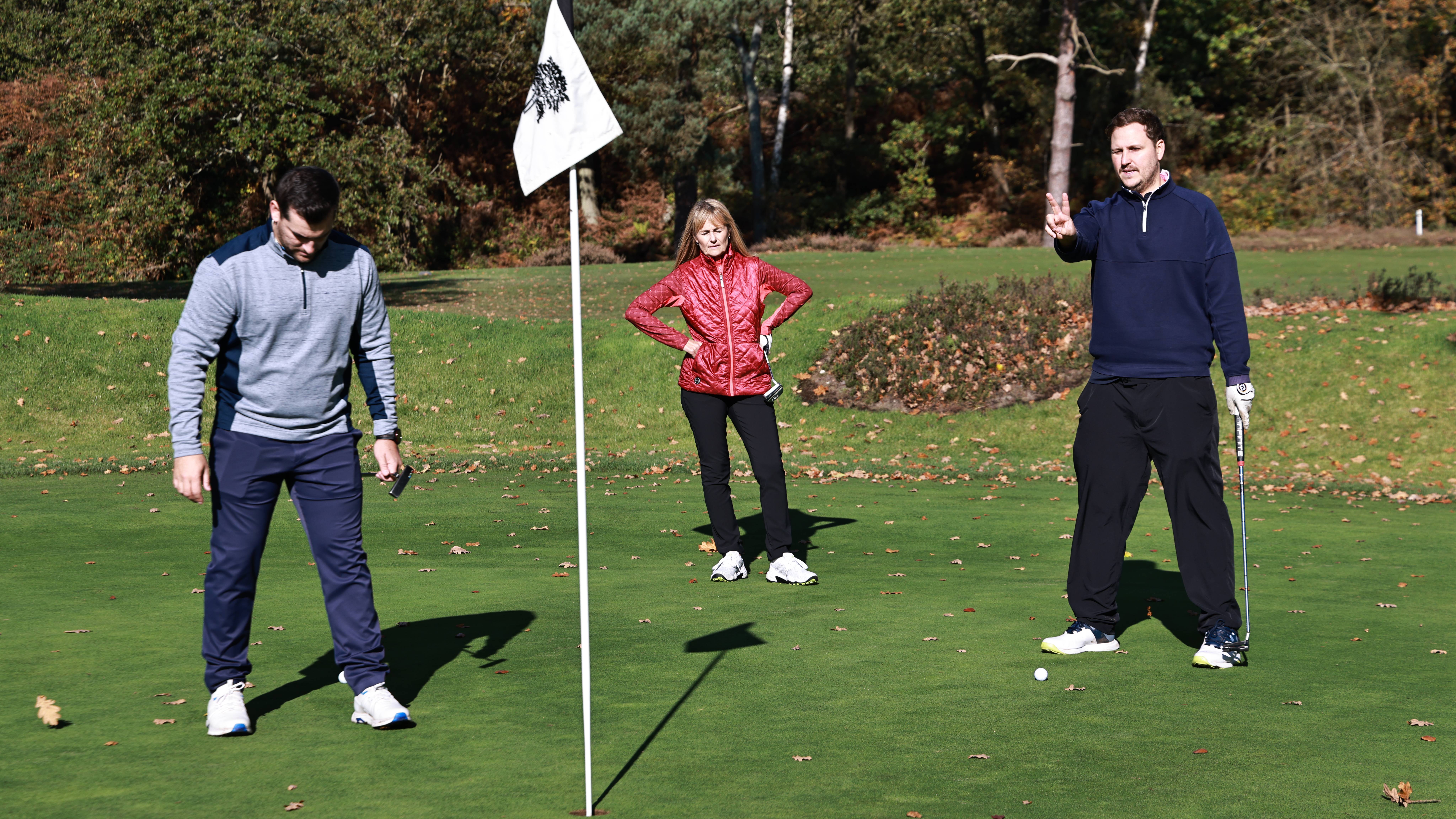 Men taking time on putting green