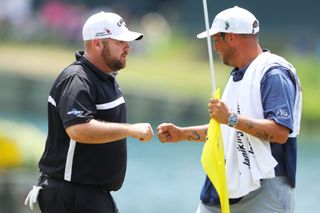 Knost fist pumps his caddie during The Players Championship