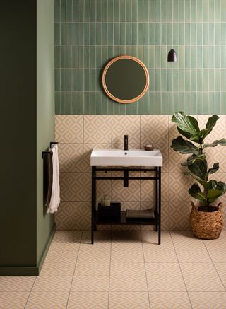 A retro tiled bathroom with a circular vanity mirror and a freestanding sink