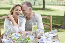 A mature couple enjoying sitting outside.
