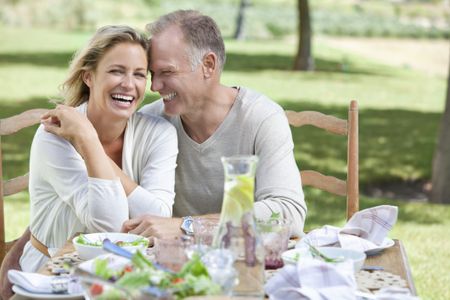 A mature couple enjoying sitting outside.