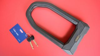 Abus Granit Super Extreme 2500 bike lock on a red table.