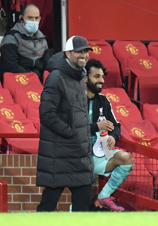 Jurgen Klopp (left) smiles with Mohamed Salah