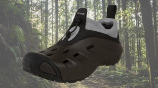 Crocs Quicktrail shoe against faded background of hiking trail