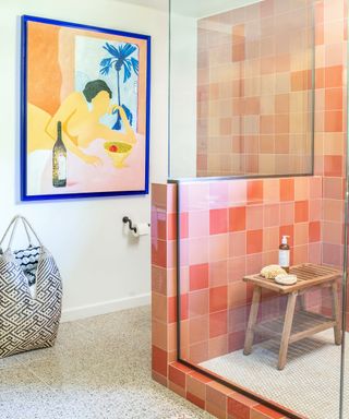 colourful bathroom with pink shower and large art on walls