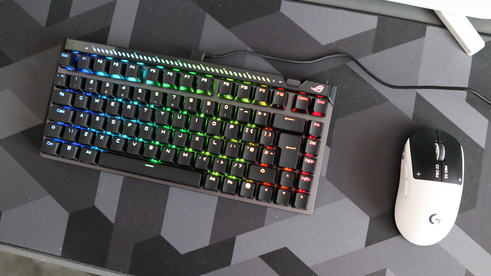 The Asus ROG Falchion Ace 75 HE on a desk with the lighting enabled.