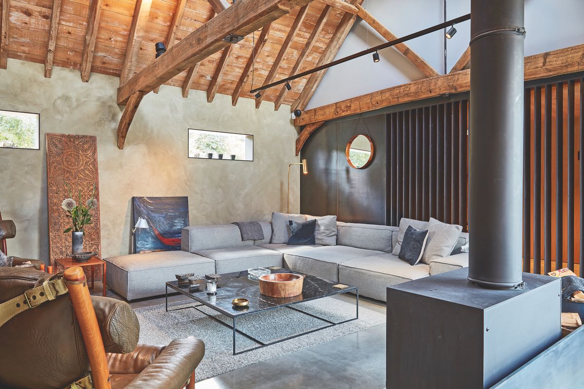 living room in barn conversion with black steel wall