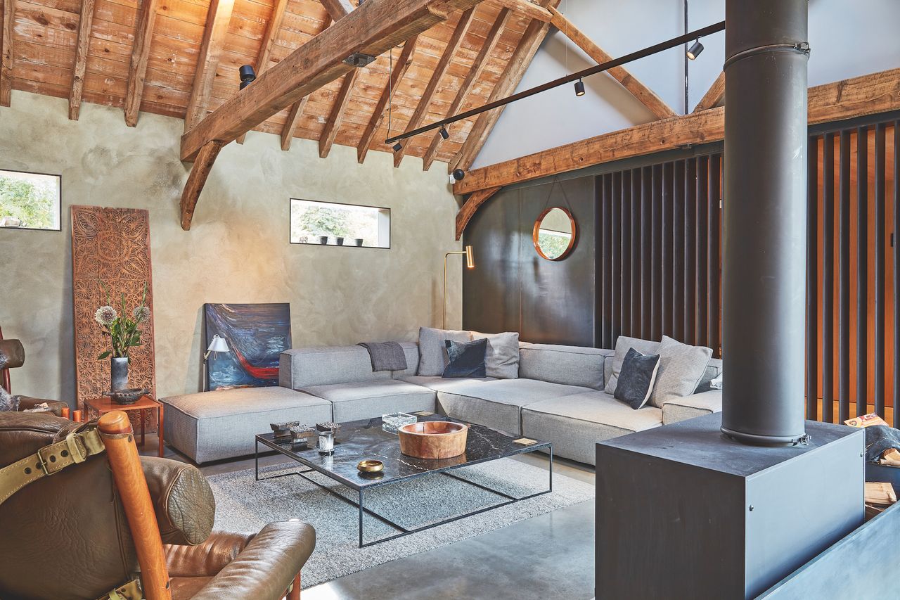 living room in barn conversion with black steel wall