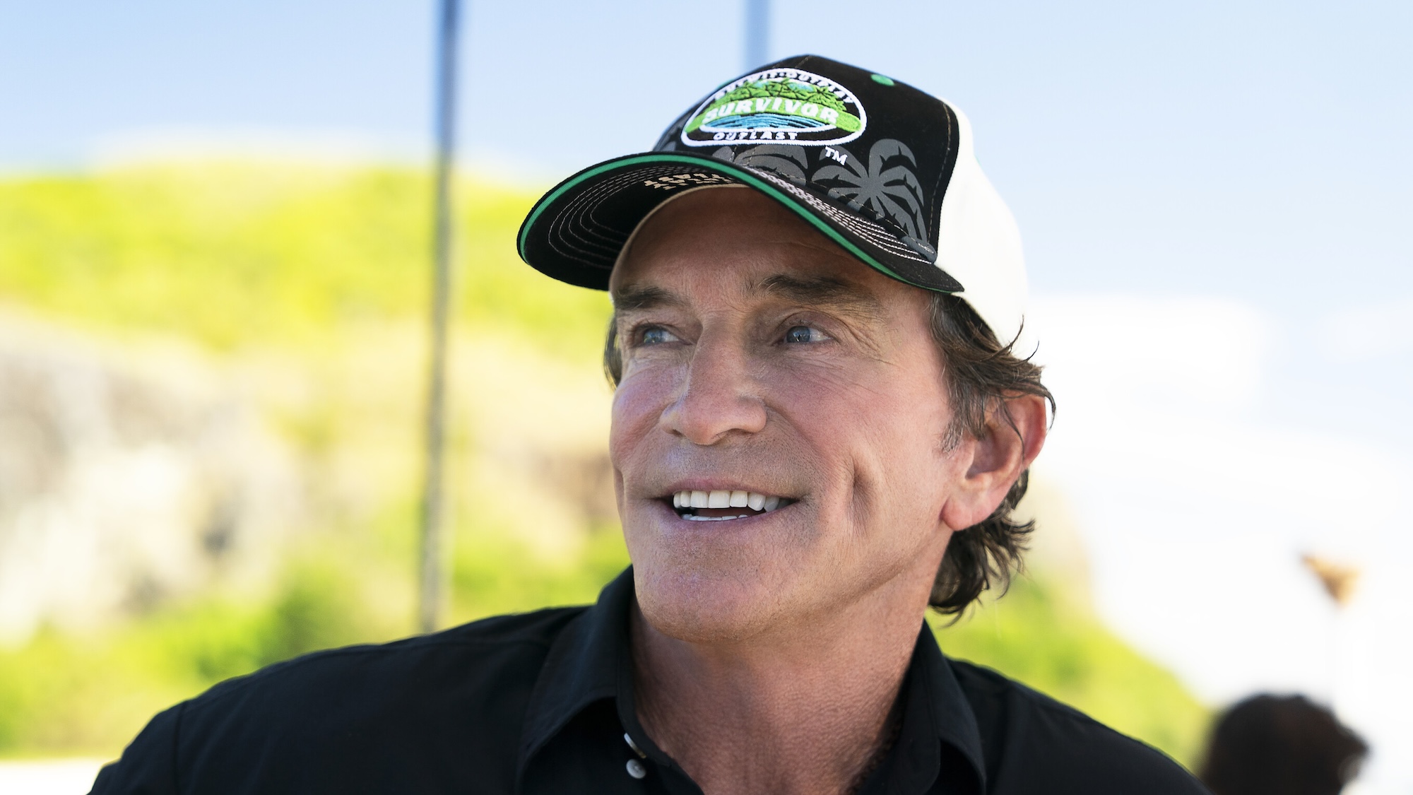 Promotional photo of Jeff Probst smiling in his hat during Survivor 51's premiere episode. 