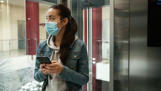 girl wearing mask in elevator
