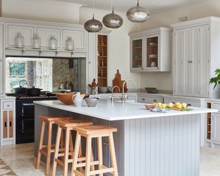 Grey and white kitchen ideas with pale grey cupboards and slatted island in a farmhouse style