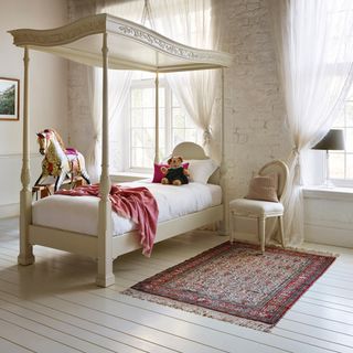 kids bedroom with four poster bedroom and wooden flooring