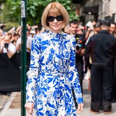 Anna Wintour wears a blue and white floral dress