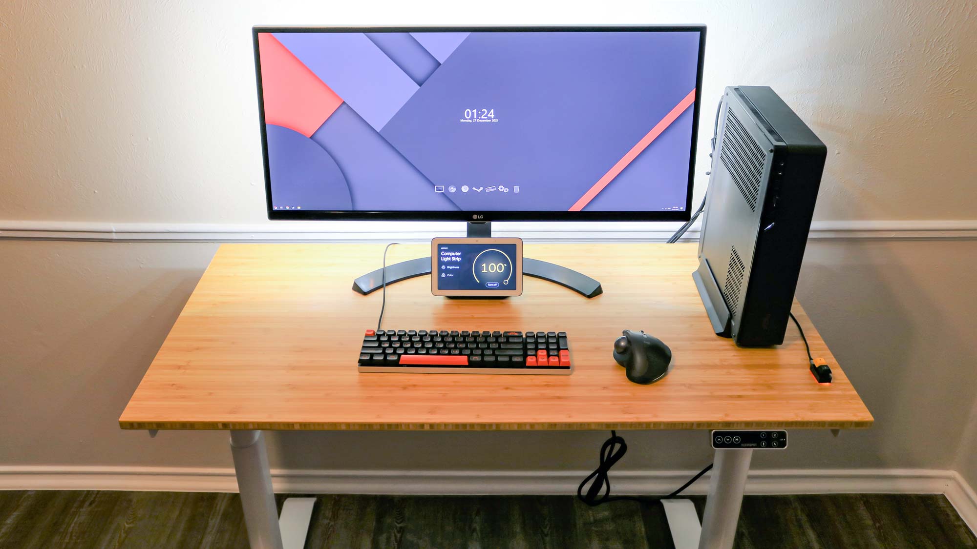 An overhead view of a standing desk with a monitor and desktop PC