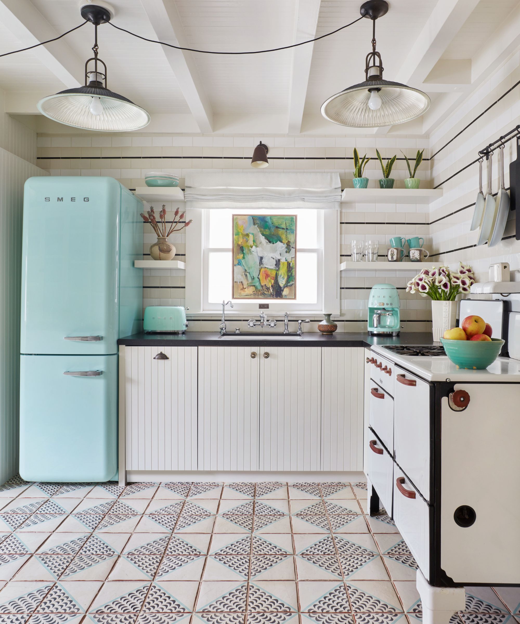 White kitchen with mint green retro Smeg appliances
