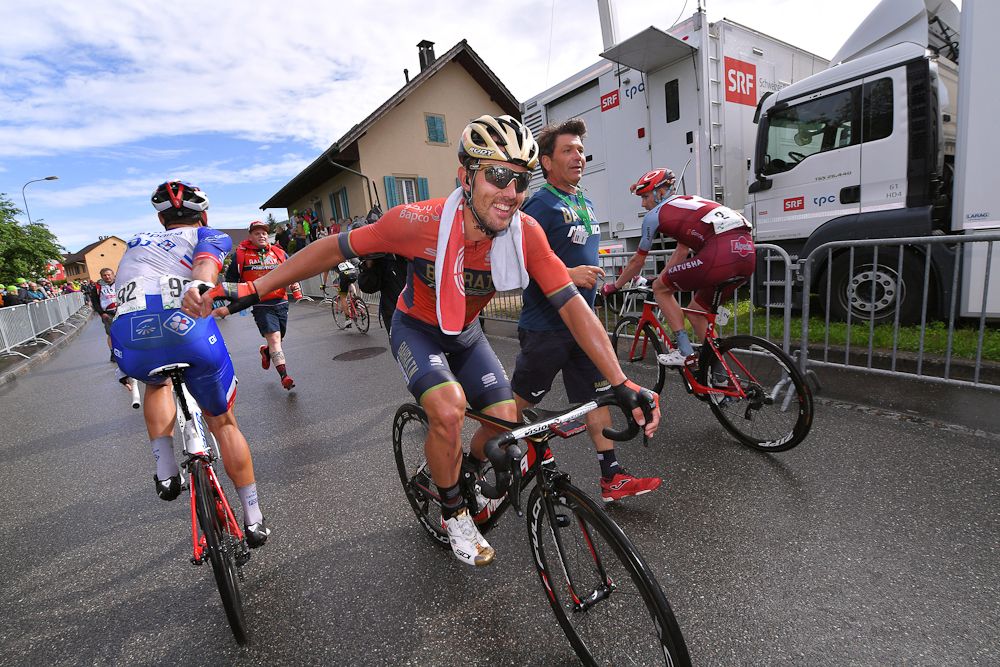 A rider congratulates Sonny Colbrelli after the Italian won stage 3 at Tour de Suisse