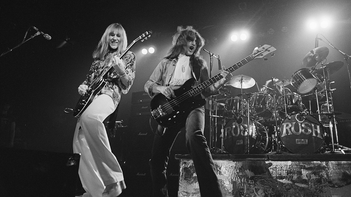 Alex Lifeson (left) and Geddy Lee performing with Rush at the Civic Center in Springfield, Massachusetts in 1976. Neil Peart is on drums (right)
