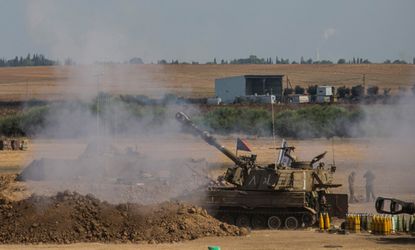 An Israeli tank fires into Gaza