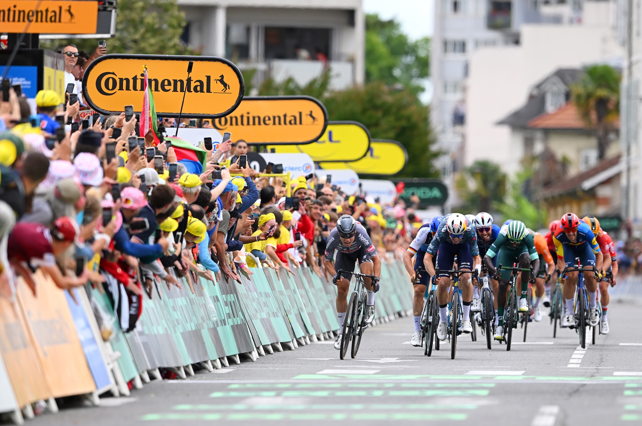 PAU, FRANCE - JULY 12: (L-R) Stage winner Jasper Philipsen of Belgium and Team Alpecin - Deceuninck, Wout Van Aert of Belgium and Team Visma | Lease a Bike, Pascal Ackermann of Germany and Team Israel - Premier Tech and Biniam Girmay of Eritrea and Team Intermarche - Wanty - Green Sprint Jersey sprint at finish line during the 111th Tour de France 2024, Stage 13 a 165.3km stage from Agen to Pau / #UCIWT / on July 12, 2024 in Pau, France. (Photo by Dario Belingheri/Getty Images)
