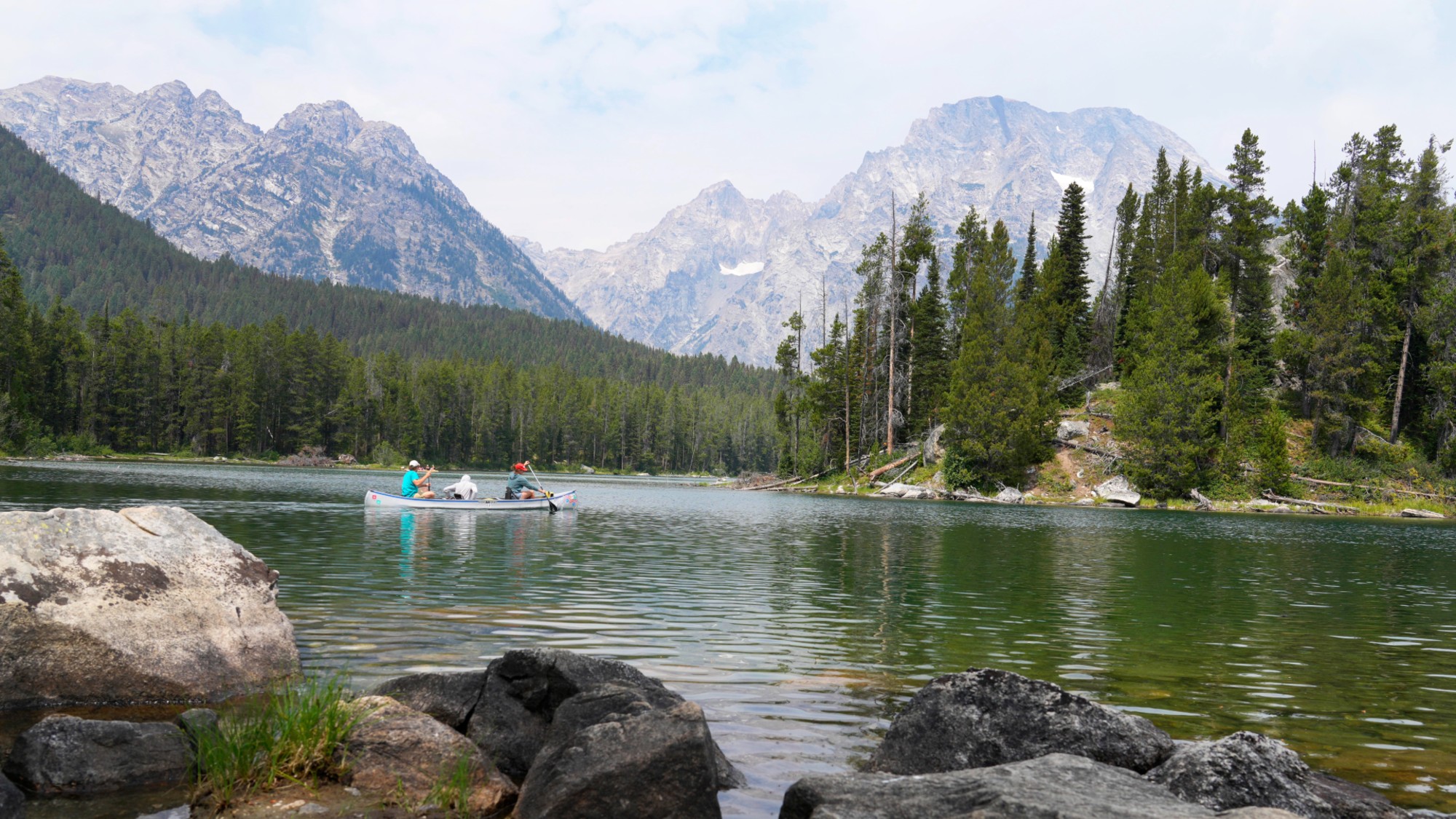 People kayak across Leigh Lake in Wyoming's Grand Teton National Park in 2024. 