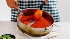 Supoon hero image, scraping tomato sauce out of a stainless steel sauté pan