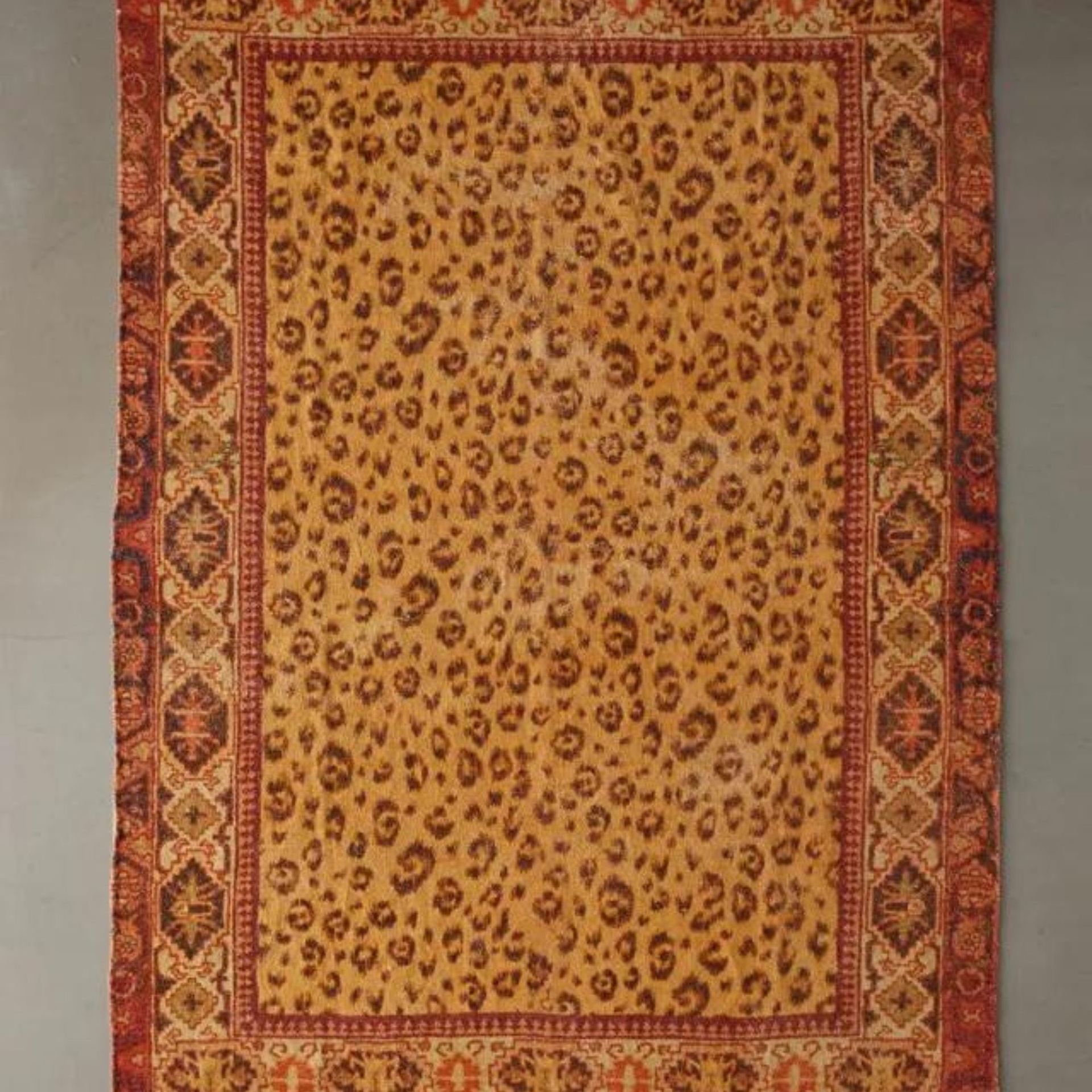 Urban Outfitters Lenore Chenille Rug against a gray background.