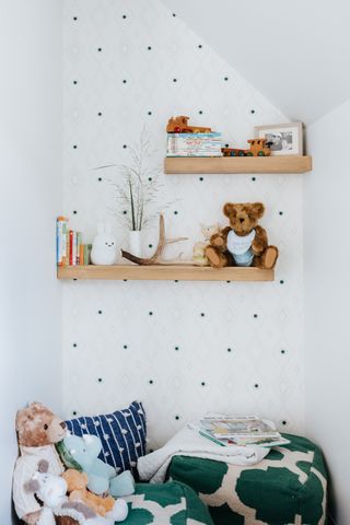 Dotty wallpaper behind shelving for children