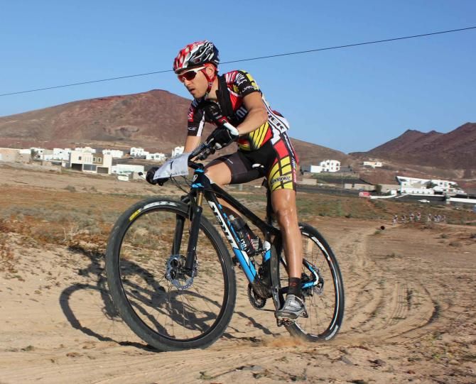 Overall winner Sergio Mantecon chases after a flat tire early on the final stage