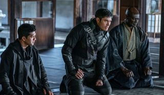 Andrew Koji, Henry Golding, and Peter Mensah kneeling with respect in Snake Eyes.