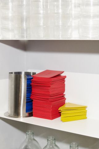 Blue, red and yellow drinks mats on shelf in London bar Bauhaus Warehaus