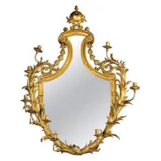 gilded mirror made of bronze with candleholders