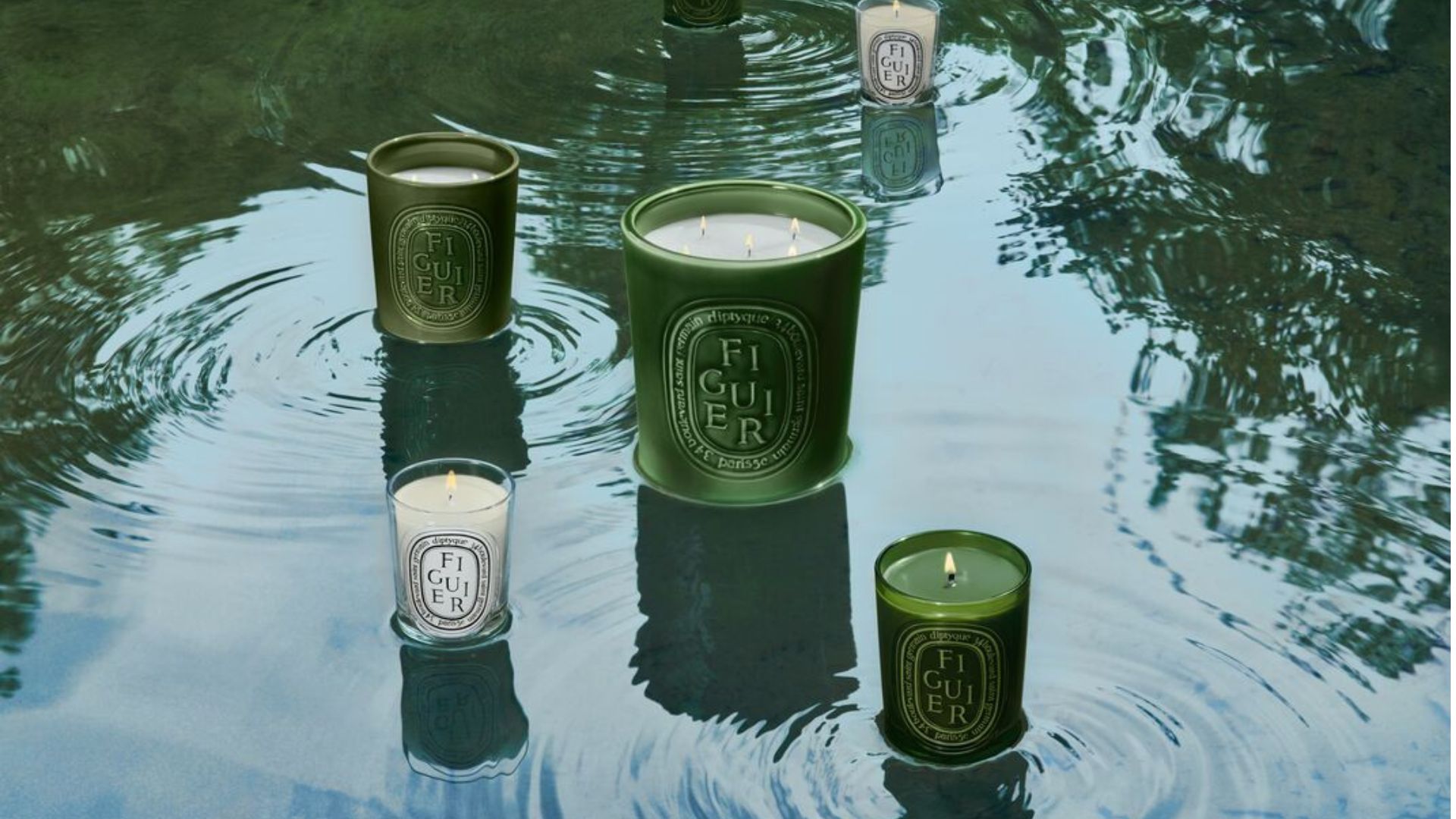 Candles from the Diptyque Summer Garden Collection launch sitting on water