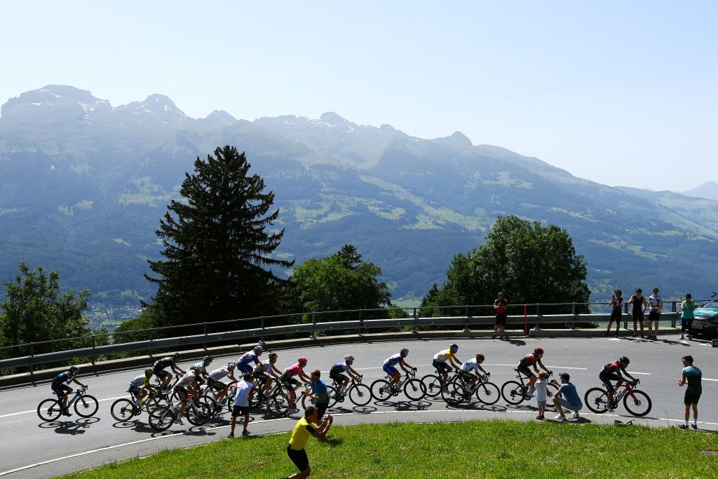 MALBUM SWITZERLAND JUNE 18 Jakob Fuglsang of Denmark and Team Israel Premier Tech Yellow Leader Jersey Sergio Andres Higuita Garcia of Colombia and Team Bora Hansgrohe White Best Young Rider Jersey Geraint Thomas of The United Kingdom and Team INEOS Grenadiers and a general view of the peloton passing through Malbunstrasse 1252m during the 85th Tour de Suisse 2022 Stage 7 a 1946km stage from Ambri to Malbun 1560m tourdesuisse2022 WorldTour on June 18 2022 in Malbun Switzerland Photo by Tim de WaeleGetty Images