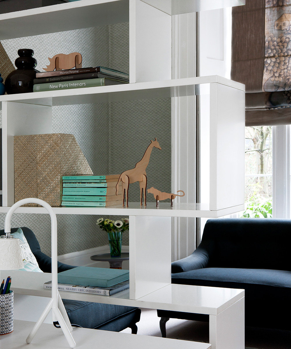 White modular shelving as a small living room storage idea.