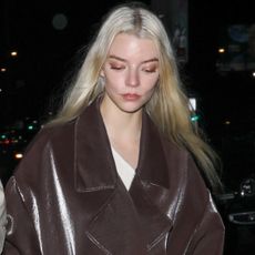Anya Taylor-Joy styled a leather brown wrap coat inspired by Fall 2025 outerwear trends