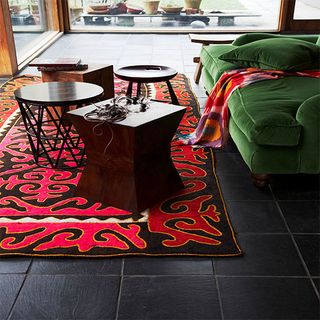 living room with tribal red rug