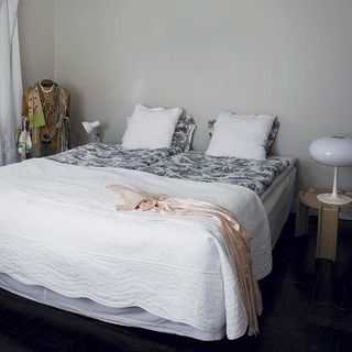 bedroom with white wall and wooden floor