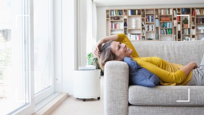 Happy woman relaxing at home on sofa