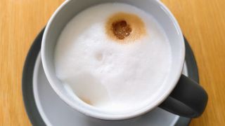 Whole milk latte made using Smeg BCC13 coffee maker, with a teaspoon of foam removed