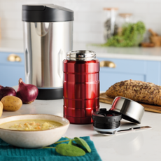 Aldi soup maker and flask next to a bowl of warm soup and crusty bread.