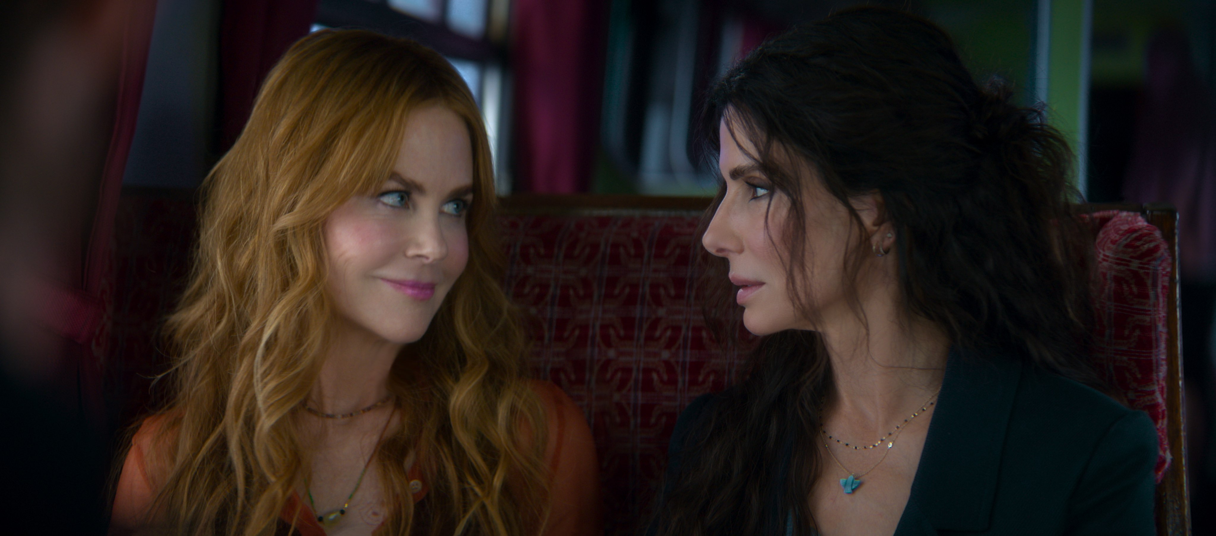 nicole kidman and sandra bullock as witch sisters smiling at each other in a first look still at practical magic 2