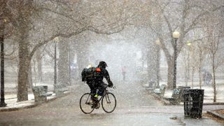 People hurry through the Boston Common during a windy snow squall in March 2004.